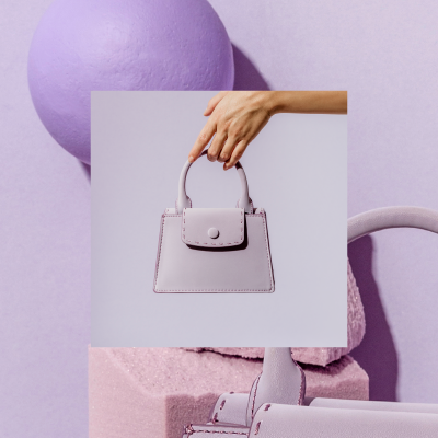 Everyday_WebHero_Visit_400x400 Hand holding lavender purse with abstract lavender background